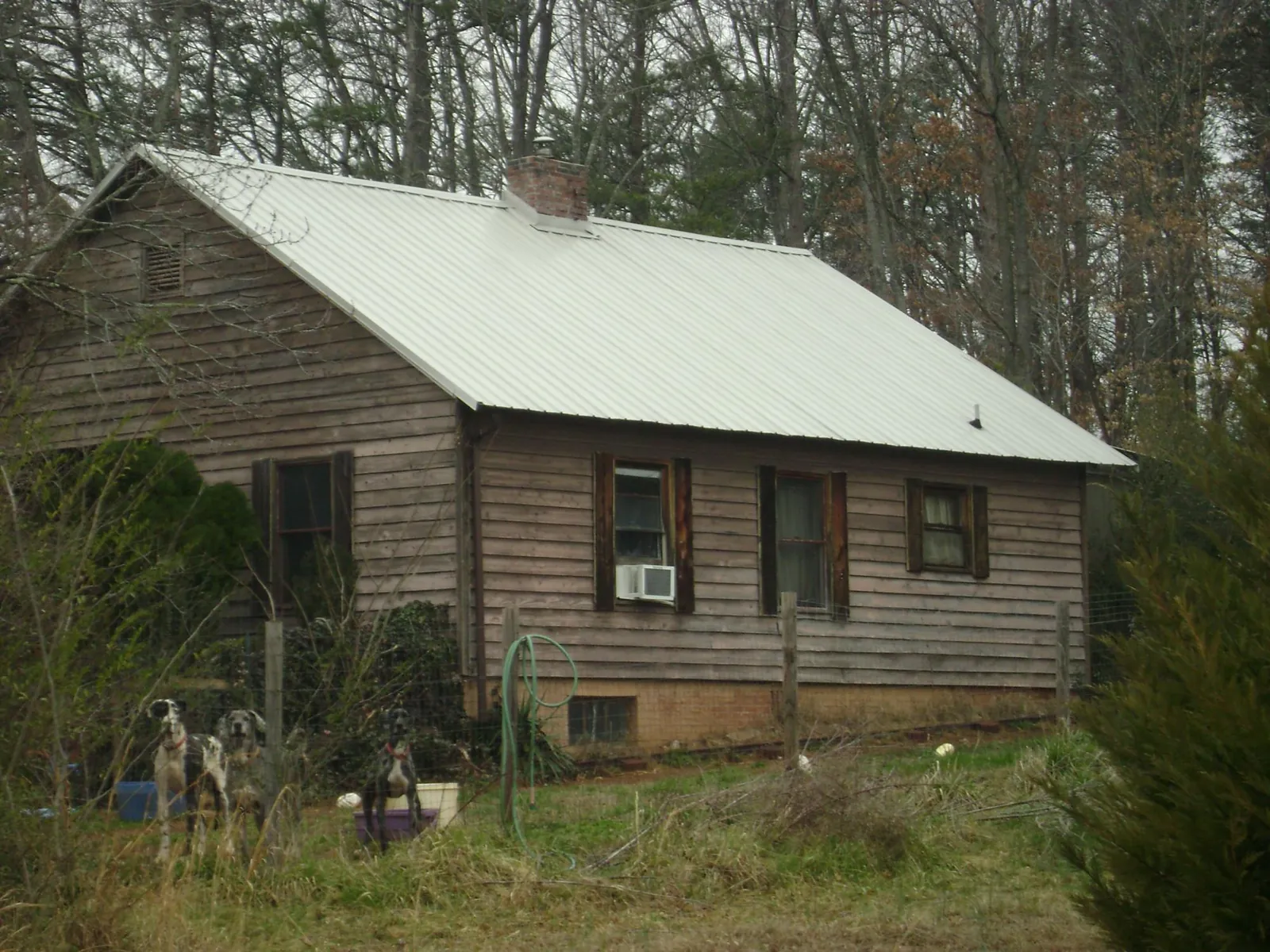 White metal roof on an old wood sided farmhouse, from a Metal Roof Installation job in Fairport